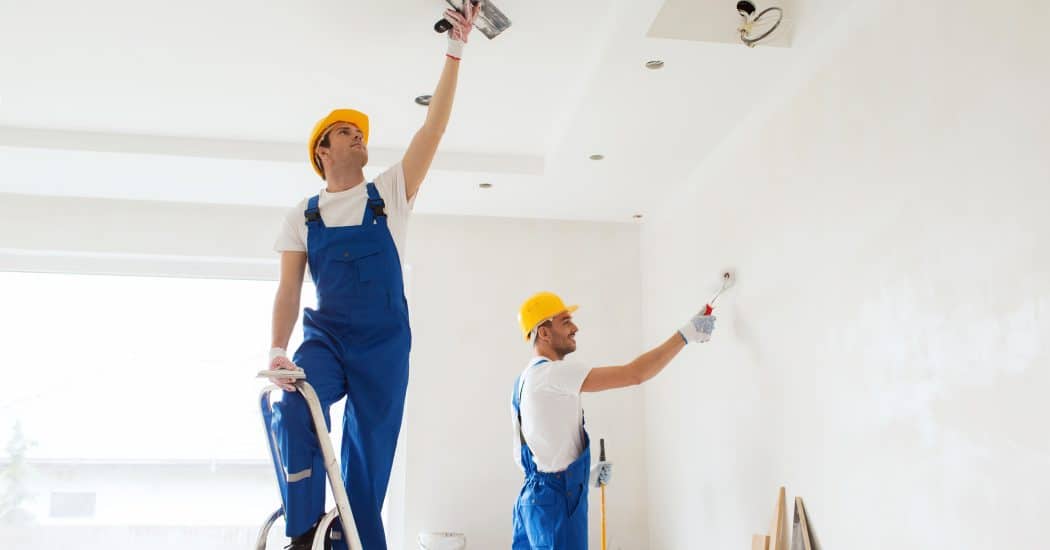 two men painting walls white - Turnkey Painters
